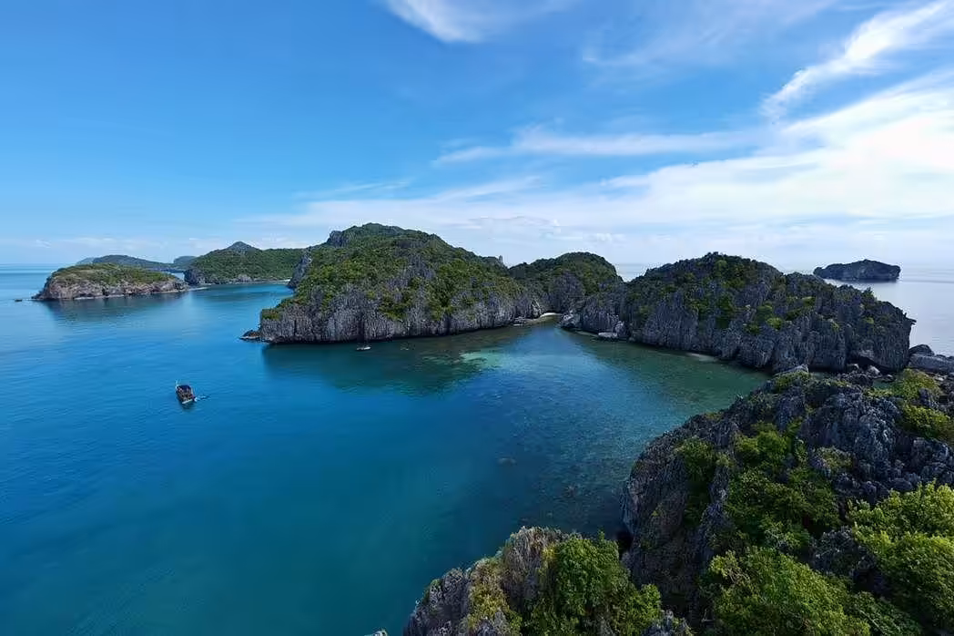 Dramatic aerial landscape of limestone karst islands and emerald lagoons in Ang Thong Marine Park from Koh Samui
