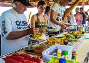 Tourists enjoying authentic Thai buffet lunch during island tour with traditional local cuisine