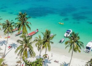 Aerial view of Ang Thong Marine Park beach with long-tail boats and emerald waters, Thailand