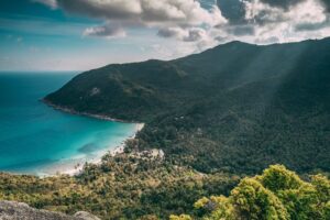 Aerial view of Koh Samui coastline showing tropical weather patterns with dramatic clouds