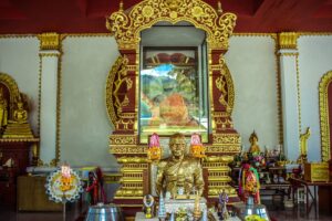 Famous mummified monk Luang Pho Daeng at ornate Buddhist temple shrine in Koh Samui, Thailand